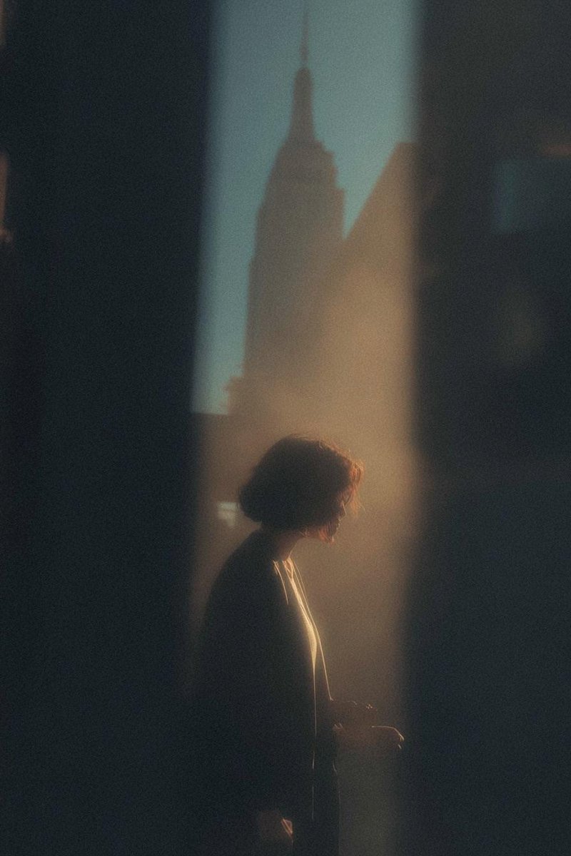 Silhouette of Serenity: A Golden Glimpse in Urban Shadows AI prompt preview